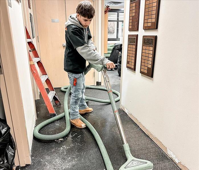 employee restoring a water damage office in Denton